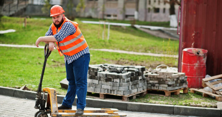 brutal-beard-worker-man-suit-construction-worker-safety-orange-helmet-with-pallet-truck